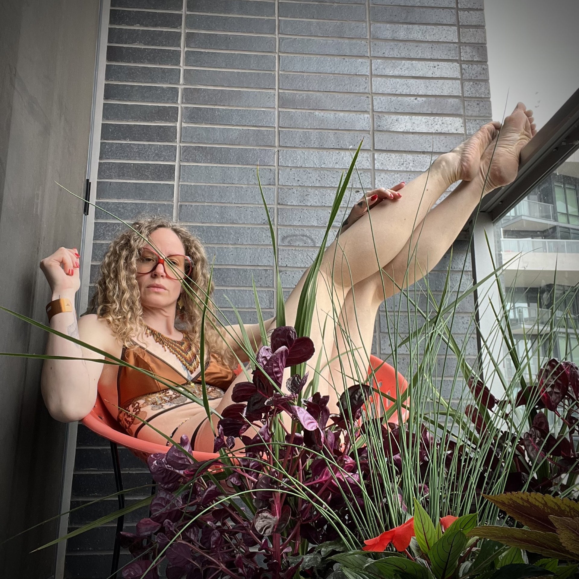 Muse of Full Moons relaxing in her garden wearing Mawu Copper set