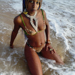 model wearing Ihuoma Nairobi Embroidery Plunge Bra and matching Nairobi Embroidery Thong in shallow ocean water 